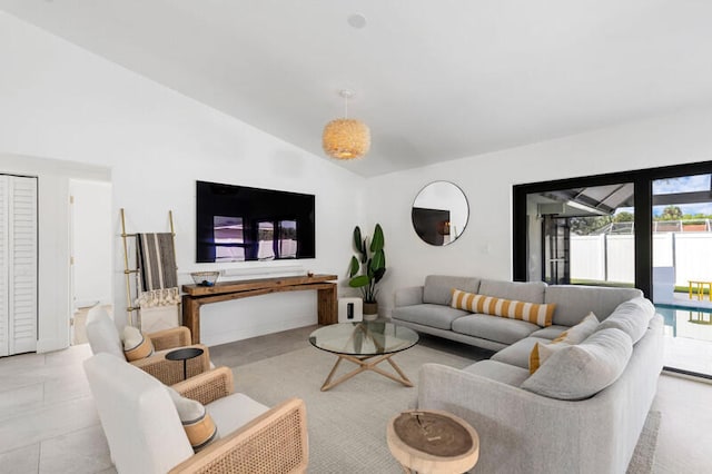 living room with light tile patterned floors and vaulted ceiling