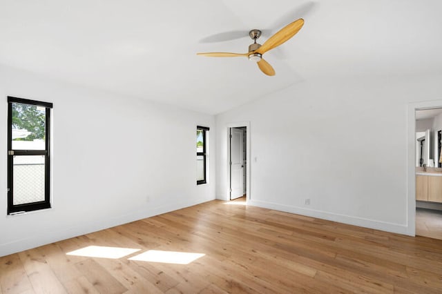 unfurnished room with light hardwood / wood-style floors, ceiling fan, and vaulted ceiling