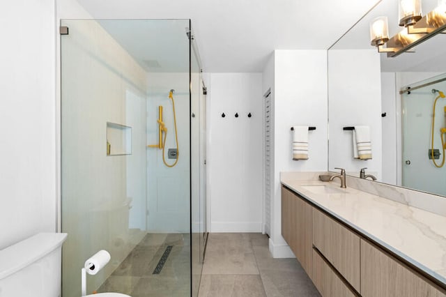 bathroom with vanity, tile patterned flooring, toilet, and an enclosed shower