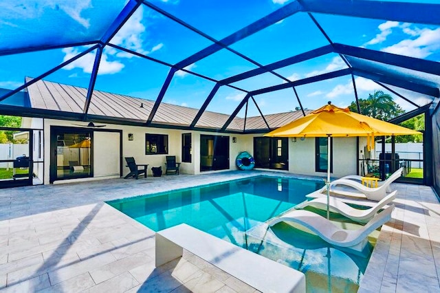 view of swimming pool featuring a patio and glass enclosure