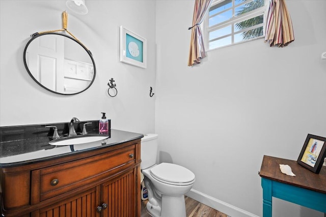 bathroom featuring hardwood / wood-style flooring, vanity, and toilet