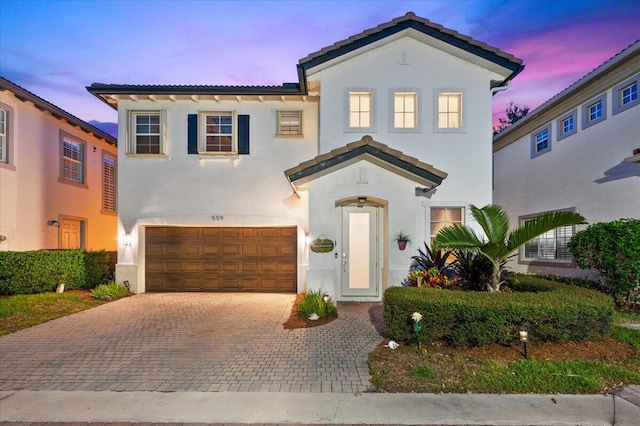 mediterranean / spanish house featuring a garage