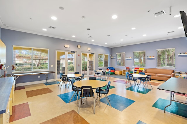 playroom with french doors and crown molding