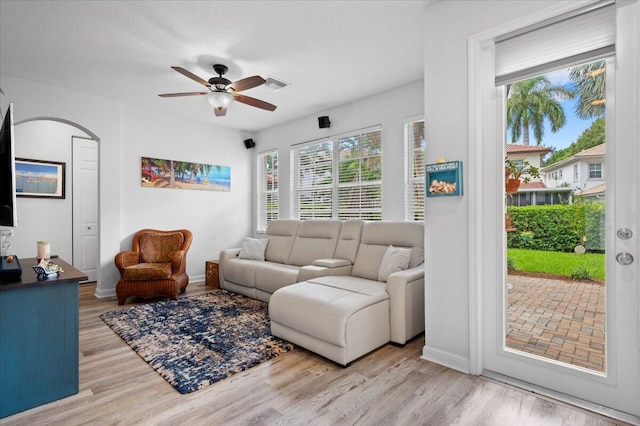 living room with light hardwood / wood-style floors and ceiling fan