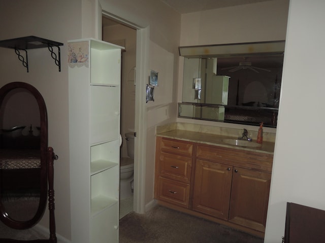 bathroom with ceiling fan, vanity, and toilet