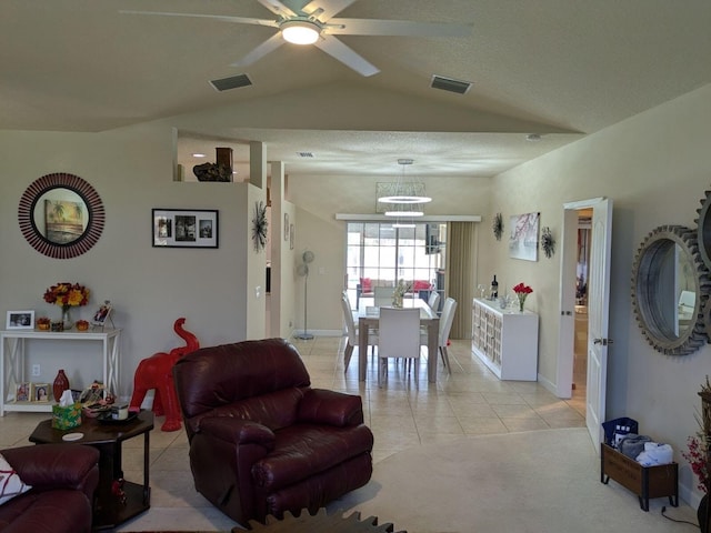 tiled living room with ceiling fan and lofted ceiling