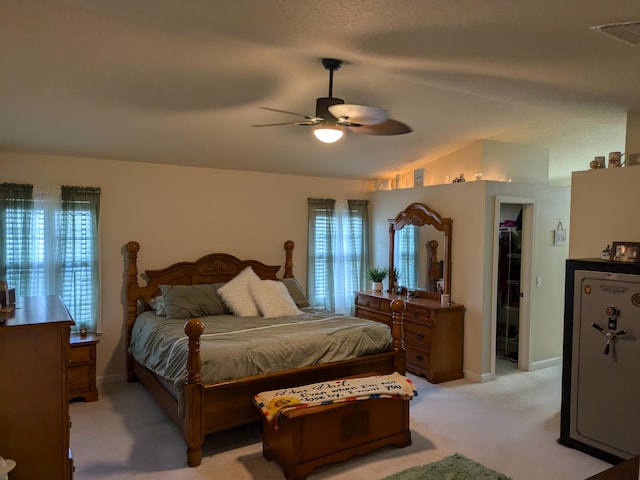 bedroom featuring ceiling fan, a closet, a walk in closet, and multiple windows