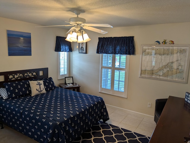 bedroom featuring light tile patterned floors, a textured ceiling, and ceiling fan