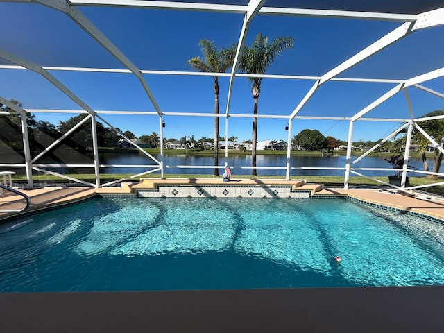 view of swimming pool with a water view and a lanai