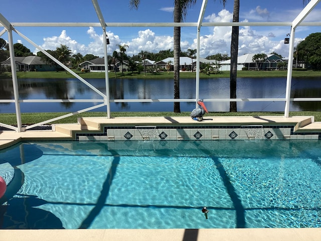 view of swimming pool featuring a lanai, a patio area, and a water view