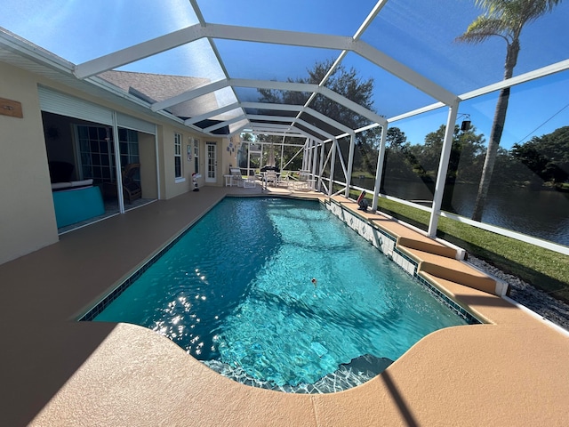 view of swimming pool with a patio, a water view, and glass enclosure