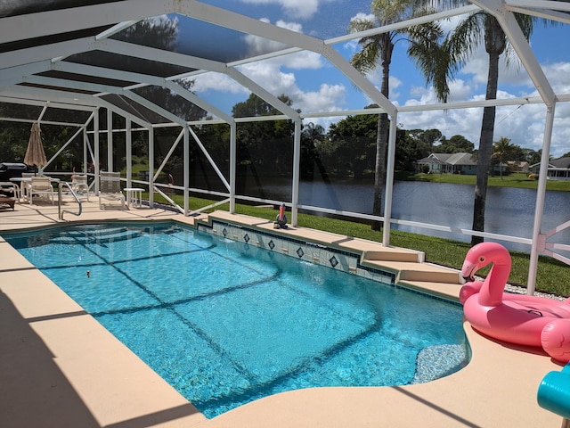 view of pool featuring a lanai, a patio, and a water view