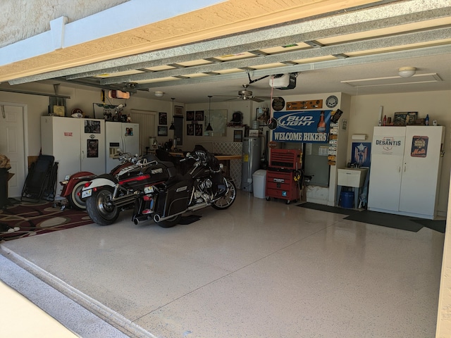 garage with ceiling fan, a garage door opener, and white refrigerator with ice dispenser