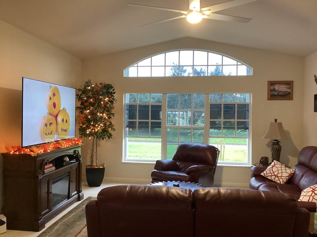 living room with vaulted ceiling, plenty of natural light, and ceiling fan