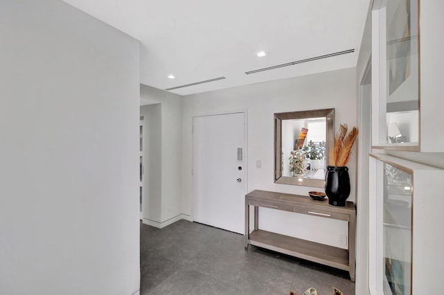 entrance foyer featuring recessed lighting and concrete flooring