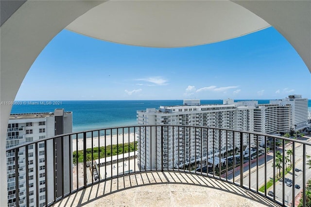 balcony featuring a water view and a view of the beach