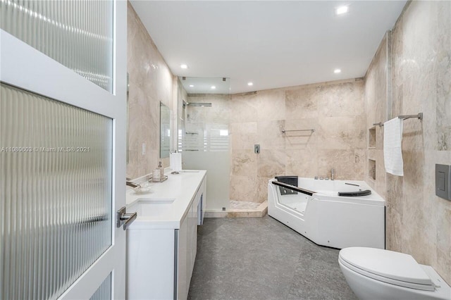 full bathroom featuring toilet, independent shower and bath, vanity, and tile walls