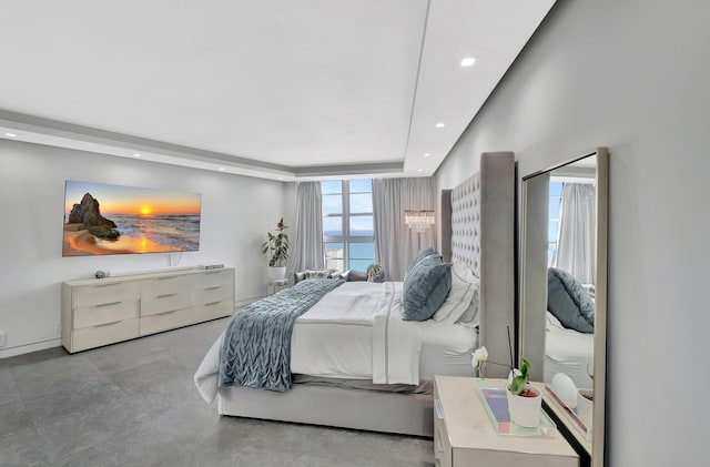 bedroom with recessed lighting and a tray ceiling