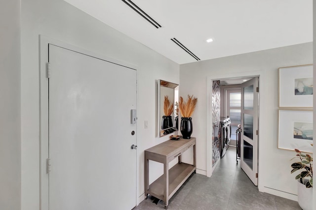 corridor featuring visible vents and washer / clothes dryer