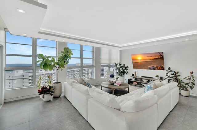 kitchen with appliances with stainless steel finishes, sink, white cabinetry, and wall chimney range hood