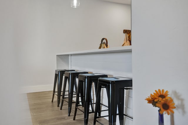 bar with light wood-type flooring