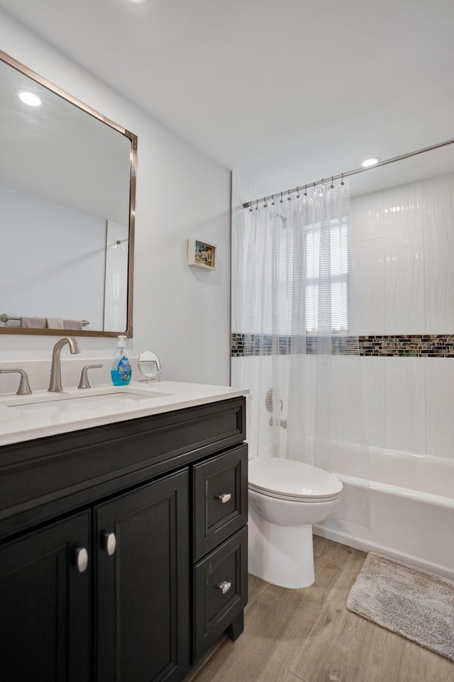 full bathroom featuring wood-type flooring, vanity, toilet, and shower / bath combination with curtain