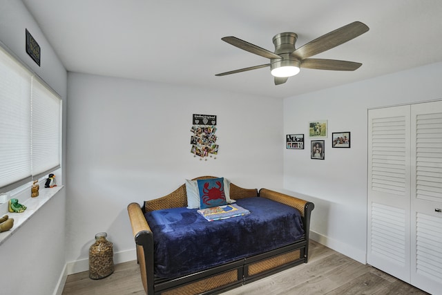 bedroom featuring ceiling fan, a closet, and light hardwood / wood-style floors