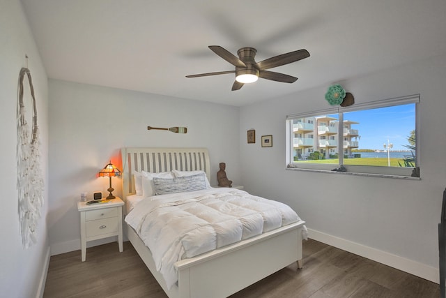 bedroom with dark hardwood / wood-style floors and ceiling fan