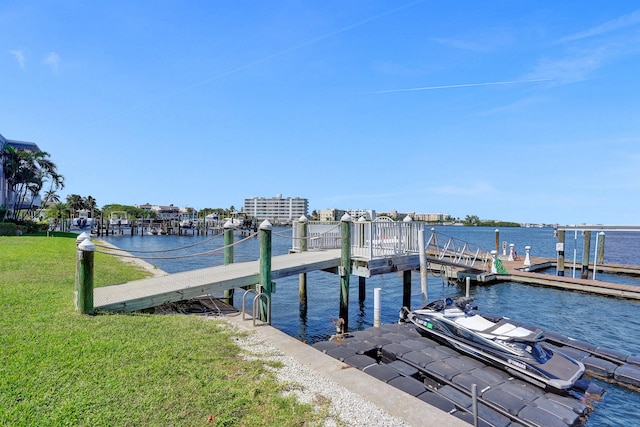 dock area with a yard and a water view