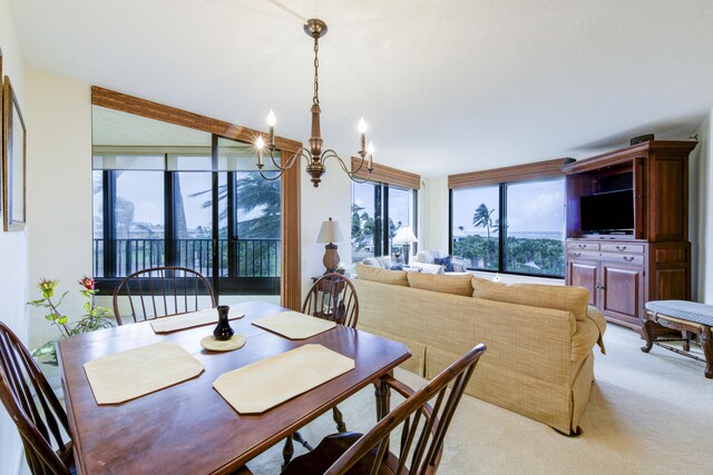 carpeted living room featuring ceiling fan with notable chandelier