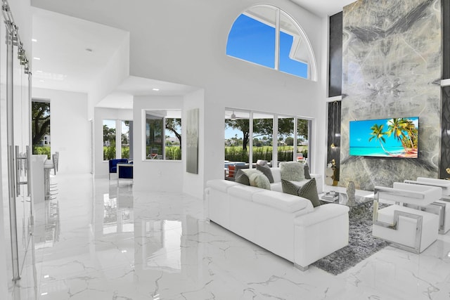 living room featuring tile walls and a towering ceiling