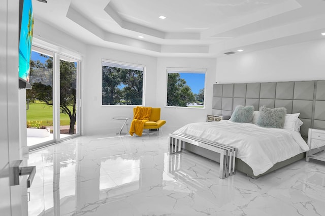 bedroom featuring a raised ceiling and access to exterior