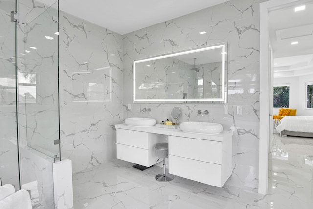 bathroom featuring tile walls, tiled shower, and vanity