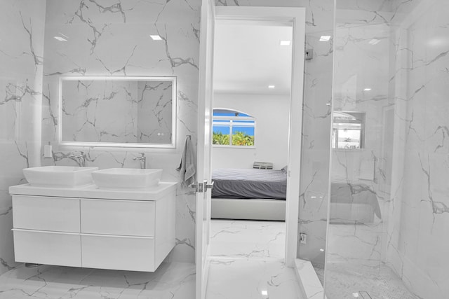 bathroom featuring vanity and tiled shower