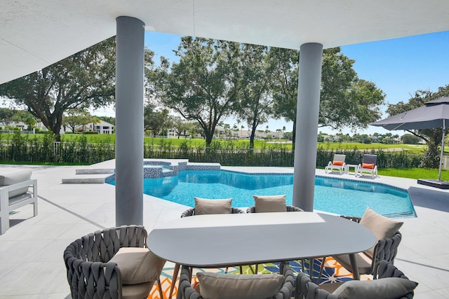 view of pool with a patio and an in ground hot tub