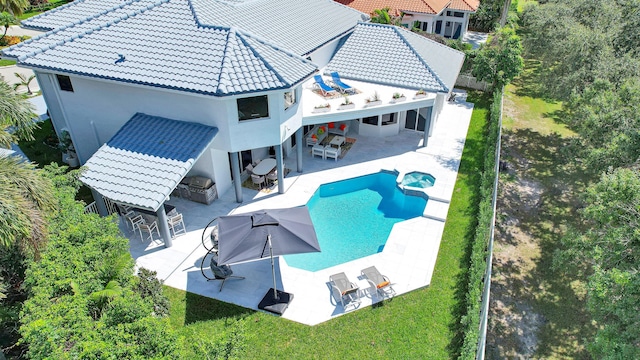 view of pool with a patio, a lawn, and an outdoor bar