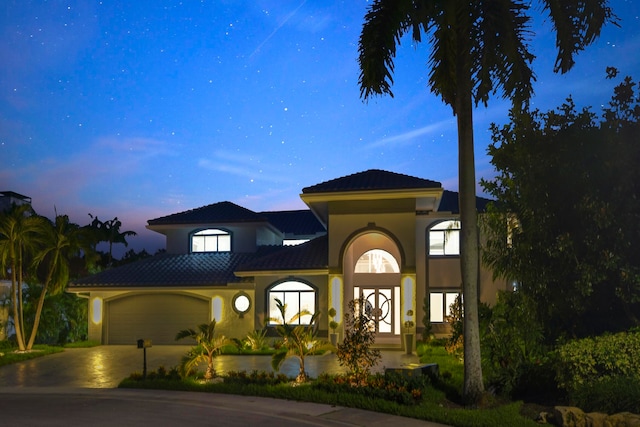 mediterranean / spanish house featuring a garage