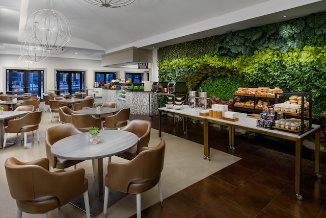 dining space with french doors, tile patterned floors, and a notable chandelier