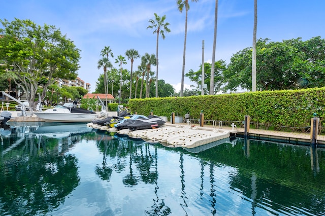 view of pool with a boat dock and a water view