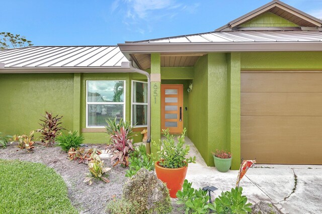 view of exterior entry featuring a garage