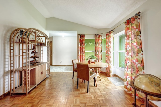 dining space with light parquet flooring, a textured ceiling, and vaulted ceiling