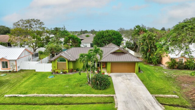 view of front of property with a front yard and a garage