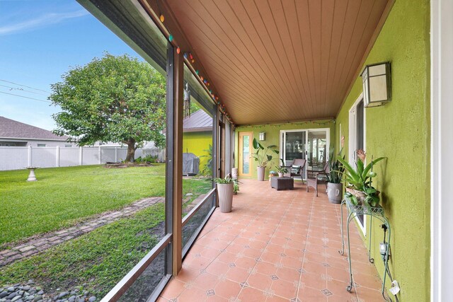 unfurnished sunroom featuring wood ceiling