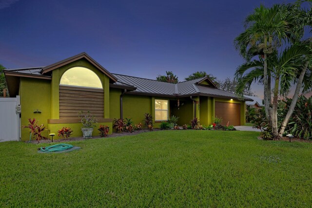 view of front facade featuring a yard and a garage