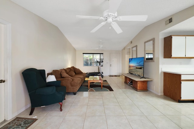 living room with ceiling fan, lofted ceiling, and light tile patterned floors