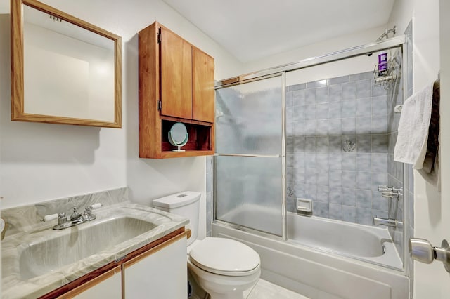 full bathroom with vanity, combined bath / shower with glass door, toilet, and tile patterned flooring