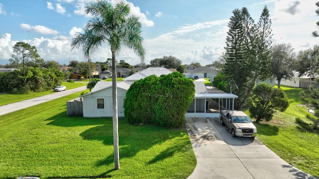 view of front of property with a carport and a front yard