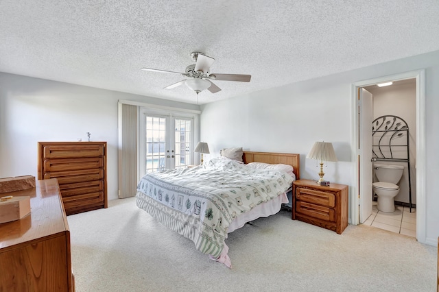 carpeted bedroom featuring ensuite bathroom, french doors, a textured ceiling, access to exterior, and ceiling fan