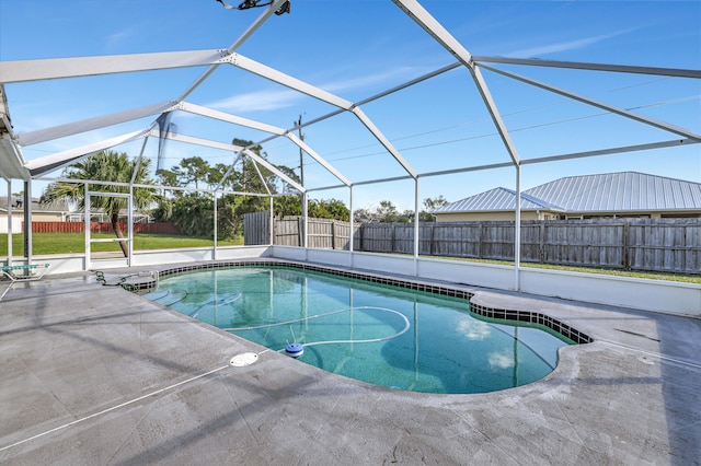 view of swimming pool with a patio and a lanai