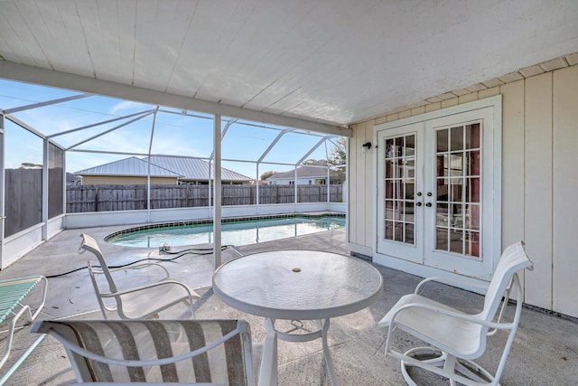 view of pool with a patio area, french doors, and glass enclosure